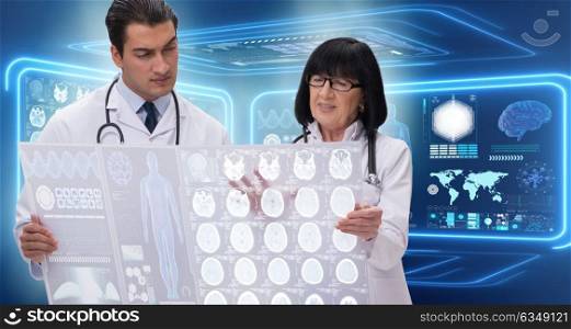 Woman and man doctor looking at MRI scan image