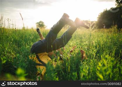 woman and man having fun outdoors. Loving hipster couple walking in the field, kissing and holding hands, hugging, lying in the grass and lifting their legs up in the summer at sunset. valentines day.. woman and man having fun outdoors. Loving hipster couple walking in the field, kissing and holding hands, hugging, lying in the grass and lifting their legs up in the summer at sunset. valentines day