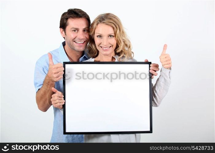 woman and man holding board