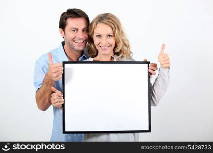 woman and man holding board