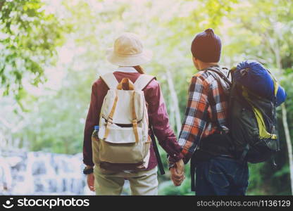 Woman and man holding Shake hands, Happy couple love Traveling tourist Backpack in forest. Travel Camping Hiking Journey holiday Concept. space for text, atmospheric moment summer vacations outdoor.