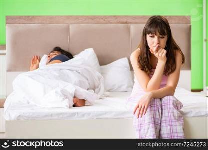 Woman and man in the bedroom after conflict. The woman and man in the bedroom after conflict