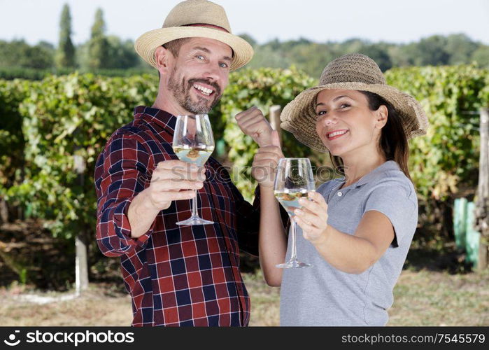 woman and man in vineyard drinking wine