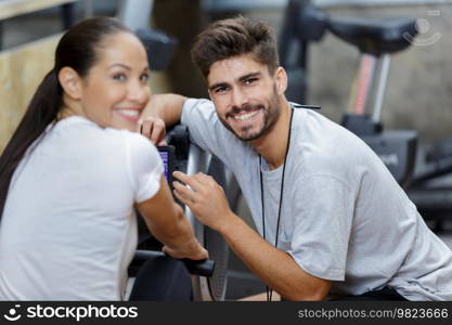 woman and man on rowing machines