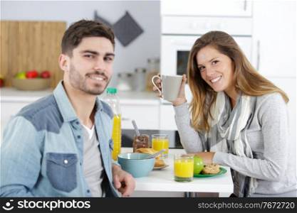 woman and man preparing breakfast in kitchen