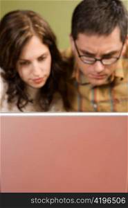 Woman and Man Staring at Laptop