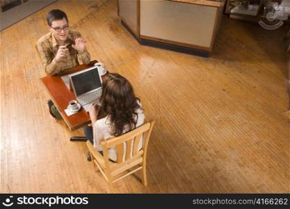 Woman and Man Talking over Computer Screen