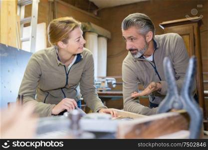 woman and man wooden working