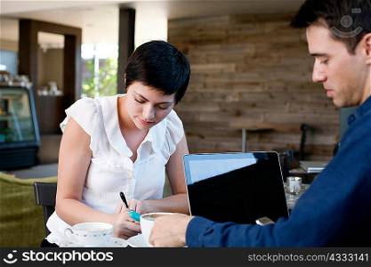 Woman and man working in a cafe