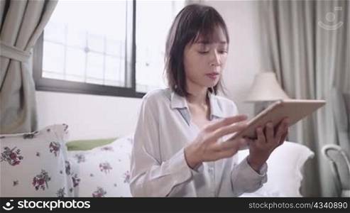 woman and modern technology, female tablet user sit down on sofa at home, on relaxing day, browsing search engine website online network connection, touch screen device, 5g cellular wireless service