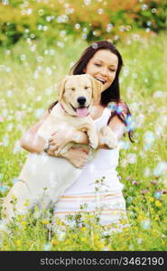 woman and she lablador dog in green grass