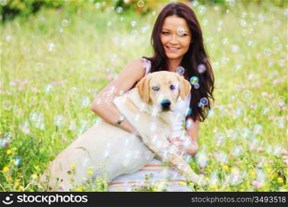 woman and she lablador dog in green grass