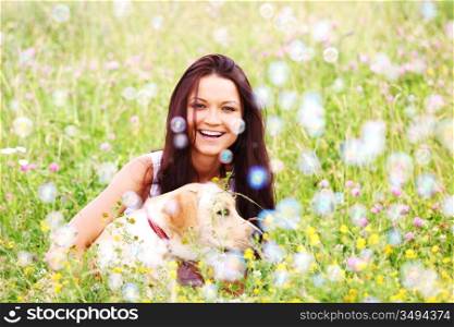 woman and she lablador dog in green grass