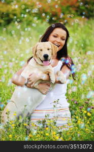 woman and she lablador dog in green grass