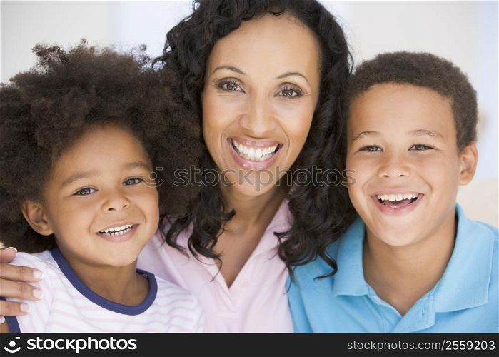 Woman and two young children smiling