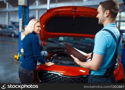 Woman and worker with checklist, car service. Female client on auto station. Automobile checking and inspection, professional diagnostics and repair. Driver and worker with checklist, car service
