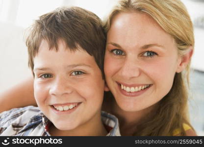 Woman and young boy in living room smiling