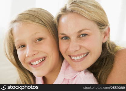 Woman and young girl in living room smiling