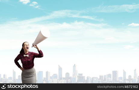 Woman announcing something. Young pretty woman screaming in paper trumpet