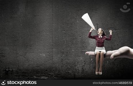 Woman announcing something. Young pretty woman screaming in paper trumpet