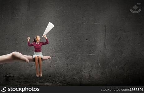 Woman announcing something. Young pretty woman screaming in paper trumpet