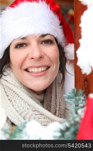 Woman answering the door in festive hat