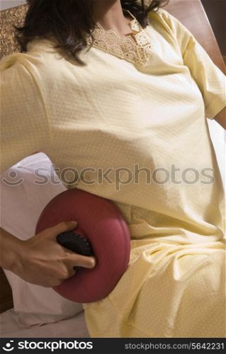 Woman applying a hot water bag