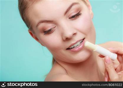 woman applying balsam for lips. Female putting applying lip balm moisturizing balsam. Girl taking care of lips. Skincare.