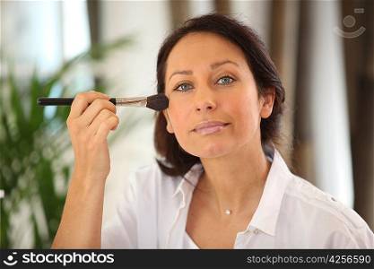 Woman applying blusher