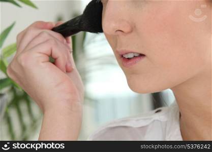 Woman applying blusher