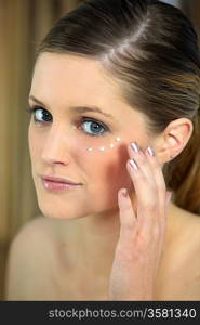 Woman applying concealer