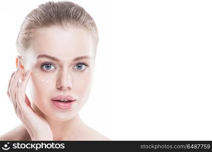 Woman applying cream. Beautiful woman with perfect skin applying cream, isolated on white background
