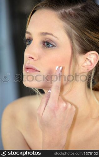 Woman applying cream on your face