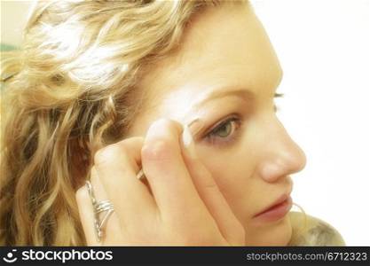 Woman applying eye make up