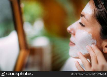 Woman Applying Face Mask at Home