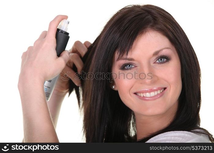Woman applying hairspray