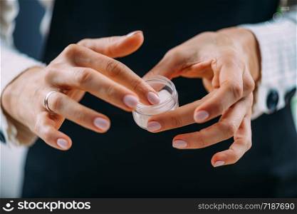 Woman Applying Homemade Hand Cream onto her Hands