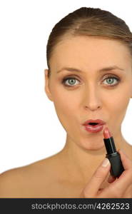 Woman applying lipstick