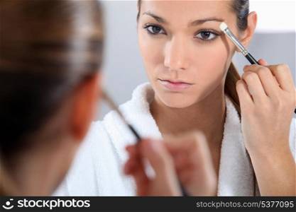 Woman applying make-up