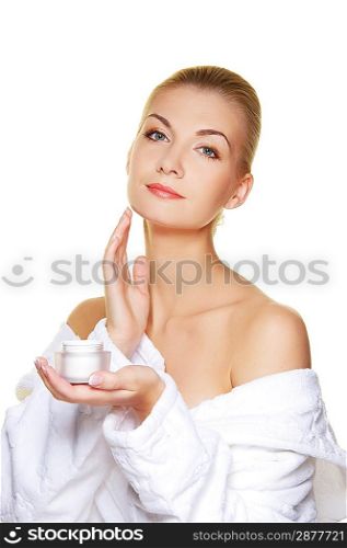 Woman applying moisturizer cream on her face