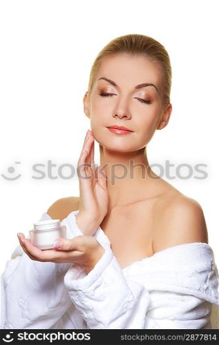 Woman applying moisturizer cream on ner face