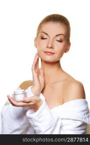 Woman applying moisturizer cream on ner face