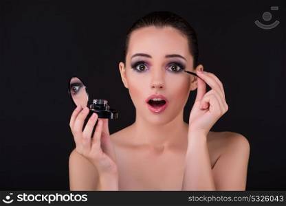 Woman applying shadows in beauty concept
