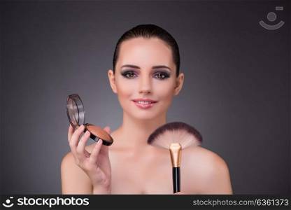 Woman applying shadows in beauty concept