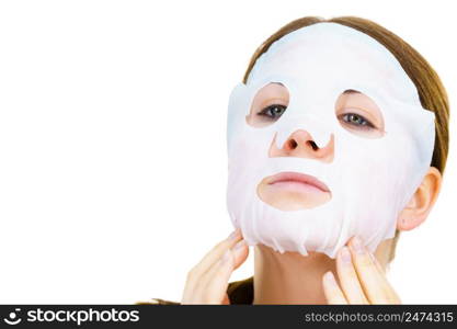 Woman applying sheet mask on her face, on white. Girl taking care of skin complexion. Beauty treatment. Skincare.. Woman applying sheet mask on face