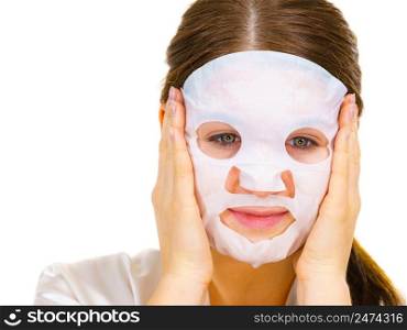 Woman applying sheet mask on her face, on white. Girl taking care of skin complexion. Beauty treatment. Skincare.. Woman applying sheet mask on face