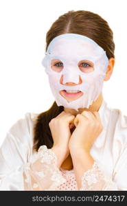 Woman applying sheet mask on her face, on white. Girl taking care of skin complexion. Beauty treatment. Skincare.. Woman applying sheet mask on face