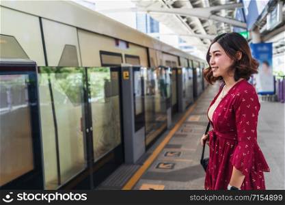 Woman are waiting sky train at station in Bangkok, Thailand
