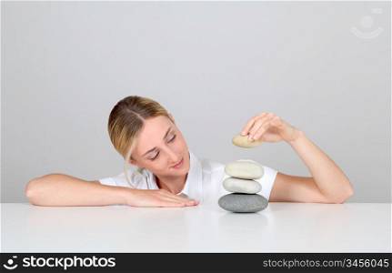Woman arranging pile of pebbles