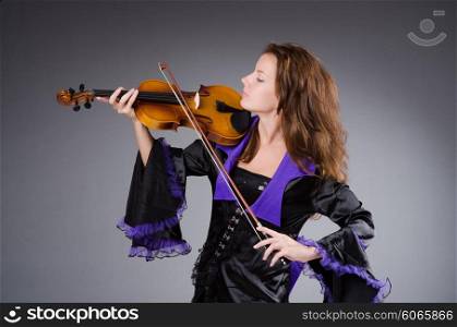 Woman artist with violin in music concept